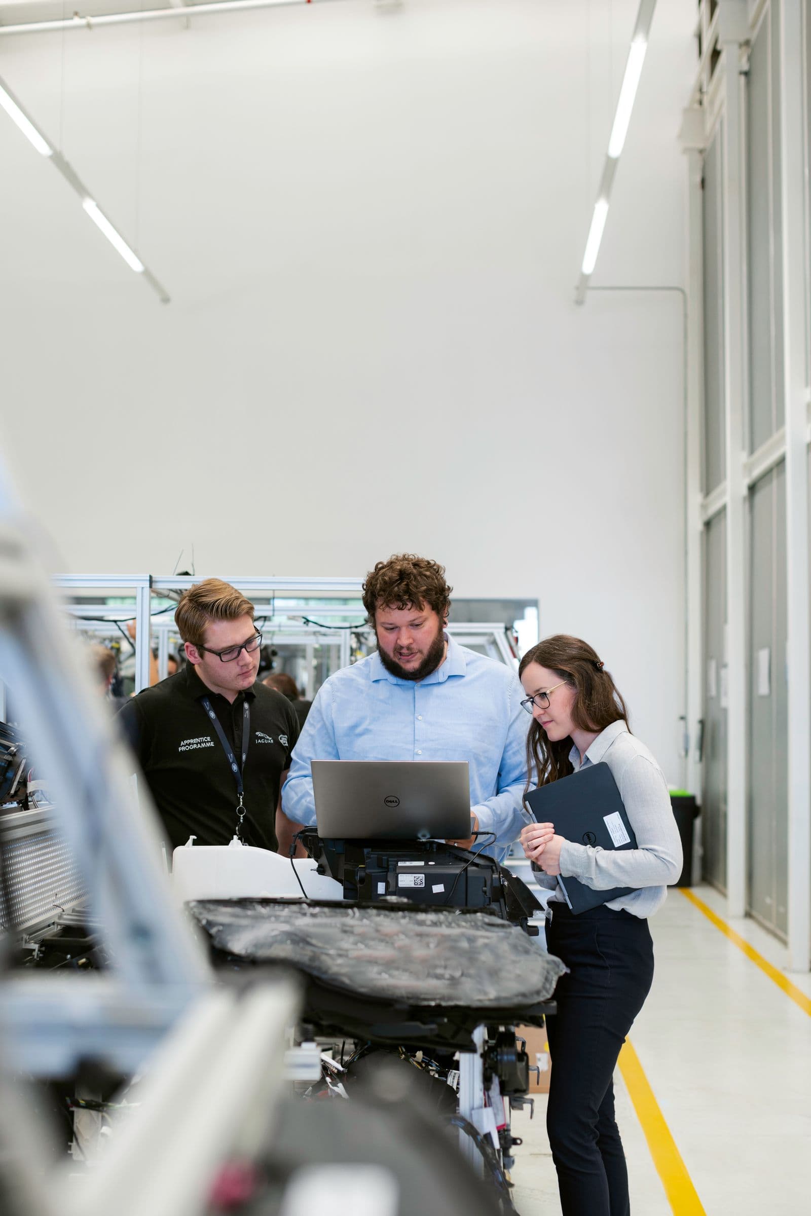 Team at a mid-sized company working on a laptop in the workshop